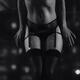 Black and white closeup of a sexy woman in lace lingerie and stockings... (thumbnail)