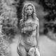 Fine art nude black and white portrait of a half-naked woman in wild f... (thumbnail)