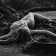Beautiful nude woman lying on the ground with roots in a forest... (thumbnail)