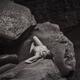 Woman lying naked on the rocks in nature scenery. Black and white art... (thumbnail)