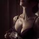 Sensual beauty portrait of a woman in lingerie spraying perfume on her... (thumbnail)