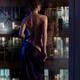 Beautiful sexy woman in undressing in front of a window with a man wat... (thumbnail)