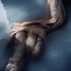 Art nude photograph of a woman lying in dark blue water with her naked... (thumbnail)
