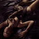 Gorgeous sexy woman with large boa constrictor snake on her body lying... (thumbnail)