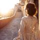 Beautiful lady in vintage Venetian carnival dress and mask standing on... (thumbnail)