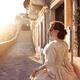 Beautiful lady in vintage Italian carnival dress and mask walking alon... (thumbnail)