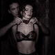 Sensual couple suggestive boudoir black and white portrait of man tyin... (thumbnail)