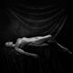 Fine art nude black and white photograph of a beautiful woman lying na... (thumbnail)