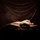 Fine art nude portrait of a beautiful woman lying naked in a sensual g... (thumbnail)