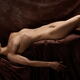 Fine art nude photograph of a beautiful young woman lying naked in a s... (thumbnail)