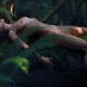Beautiful nude woman with wet shiny body lying naked in a sensual pose... (thumbnail)