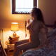 Beautiful woman with sensual nude body getting up naked from a bed in... (thumbnail)