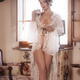Gorgeous seductive lady in sheer undone white lace nightgown revealing... (thumbnail)