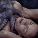 Nude woman lying on a shore with octopus caressing her naked body with... (thumbnail)