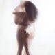 Sensual surreal photograph of a nude couple kissing in an embrace with... (thumbnail)