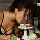 Sensual portrait of a woman in sexy lingerie licking off a dessert wit... (thumbnail)