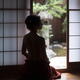 Silhouette of a beautiful woman with naked back sitting by an open doo... (thumbnail)