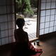 Silhouette of a woman with naked back sitting inside by an open Shoji... (thumbnail)