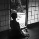 Silhouette of a woman with bared back sitting inside by an open Shoji... (thumbnail)