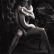 Black and white portrait of a seductive woman sitting in a chair with... (thumbnail)