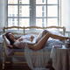 Gorgeous half naked woman in sheer white lace nightgown lying relaxed... (thumbnail)