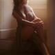 Sensual boudoir portrait of a sexy young woman in unbuttoned sheer dre... (thumbnail)