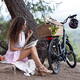 Young pretty woman reading a book enjoying a little picnic in summer c... (thumbnail)