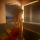 Young nude woman undressing entering naked into a steamy indoor onsen... (thumbnail)