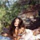 Young woman enjoying herself at a picnic in the nature with a book in... (thumbnail)