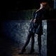 Sexy woman dressed in black leather coat and black stockings standing... (thumbnail)
