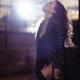 Beautiful sexy woman in black exhaling cigarette smoke with abandon an... (thumbnail)