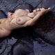 Beautiful nude woman with wet sexy body lying in dark sea water caress... (thumbnail)