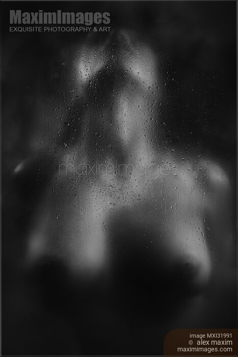 Stock photo of Abstract nude sexy woman with ecstatic moaning expression behind a wet hazy glass in dark Black and white Buy commercial use license at MaximImages