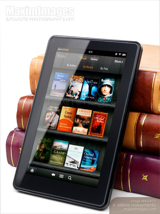 Stock photo of Amazon Kindle Fire leaning against hardcover books Buy commercial use license at MaximImages