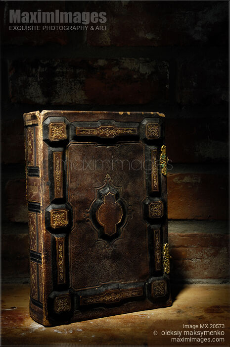 Ancient Book Illuminated in Darkness Stock photo of Ancient Book Illuminated in Darkness Buy commercial use license at MaximImages