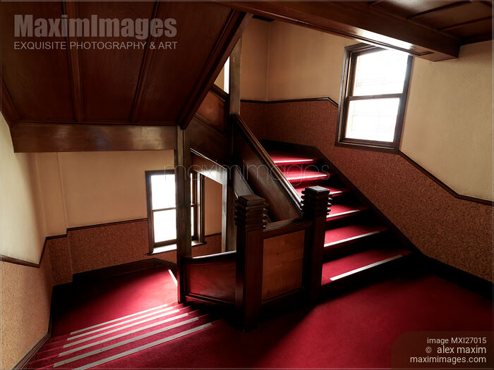 Stock photo of Antique wooden staircase with red carpet Buy commercial use license at MaximImages