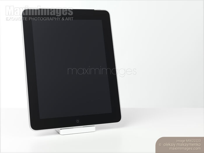 Stock photo of Apple iPad 3G Tablet Computer in a Dock Buy commercial use license at MaximImages
