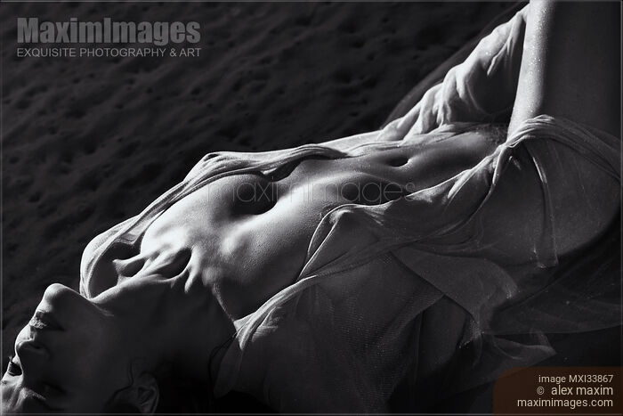 Art nude back and white, half-naked woman lying in sea water her naked sensual body barely covered with sheer clothes Stock photo of Art nude back and white, half-naked woman lying in sea water her naked sensual body barely covered with sheer clothes Buy commercial use license at MaximImages