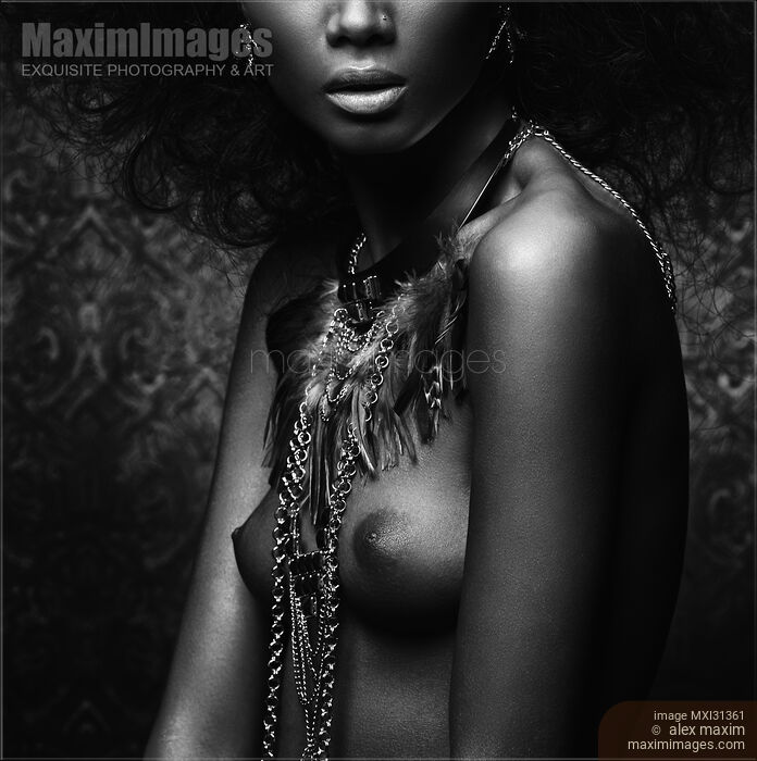 Artistic black and white nude native woman breast with a feather necklace on her bare chest Stock photo of Artistic black and white nude native woman breast with a feather necklace on her bare chest Buy commercial use license at MaximImages