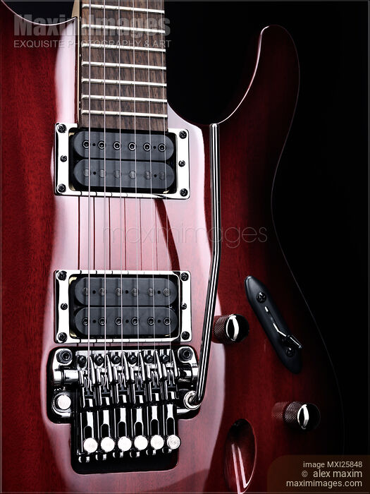 Stock photo of Artistic closeup of red electric guitar Buy commercial use license at MaximImages