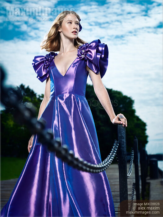 Artistic fashion portrait of woman in beautiful long blue dress at a pier Stock photo of Artistic fashion portrait of woman in beautiful long blue dress at a pier Buy commercial use license at MaximImages