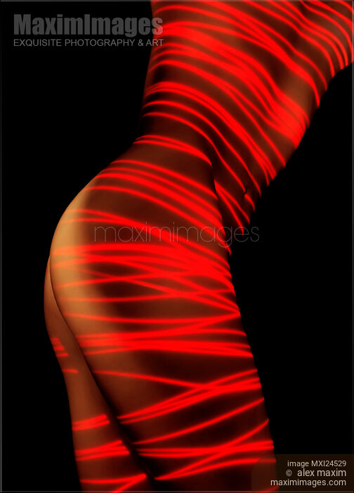Stock photo of Artistic nude woman body painted with red laser Buy commercial use license at MaximImages