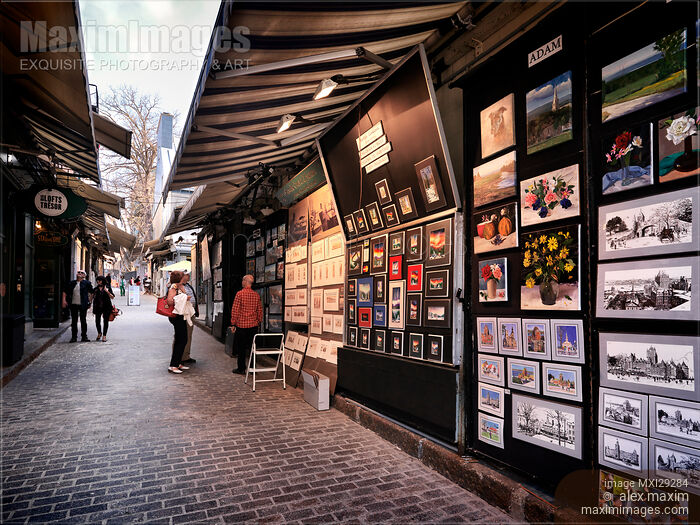 Stock photo of Artistic passage with displays of paintings in the old Quebec City Buy commercial use license at MaximImages