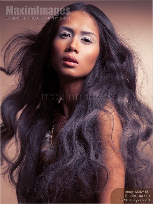 Artistic portrait of a beautiful young woman with long wavy hair Stock photo of Artistic portrait of a beautiful young woman with long wavy hair Buy commercial use license at MaximImages