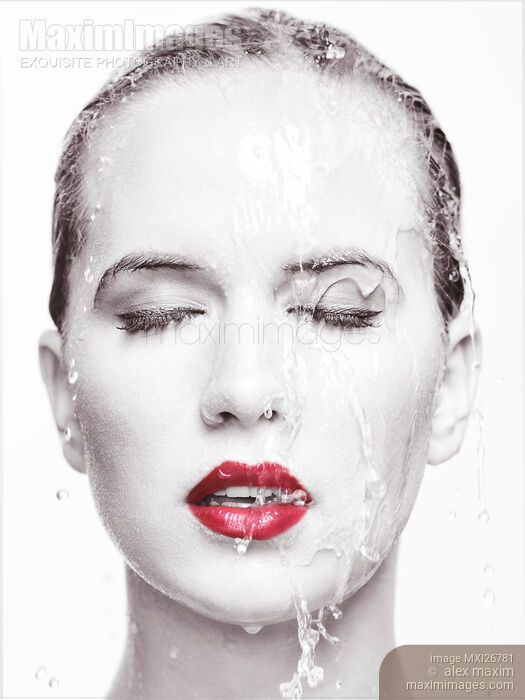 Stock photo of Artistic portrait of woman with red lipstick and water running over her face Buy commercial use license at MaximImages