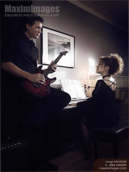 Stock photo of Artistic portrait of Young couple playing music Buy commercial use license at MaximImages