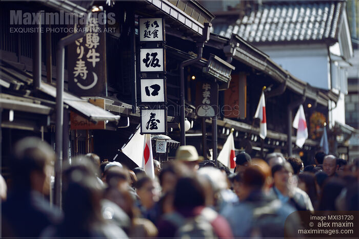 Stock photo of Artistic scenery of busy with tourists Kami-Sannomachi old town street of Hida-Takayama during holidays Buy commercial use license at MaximImages