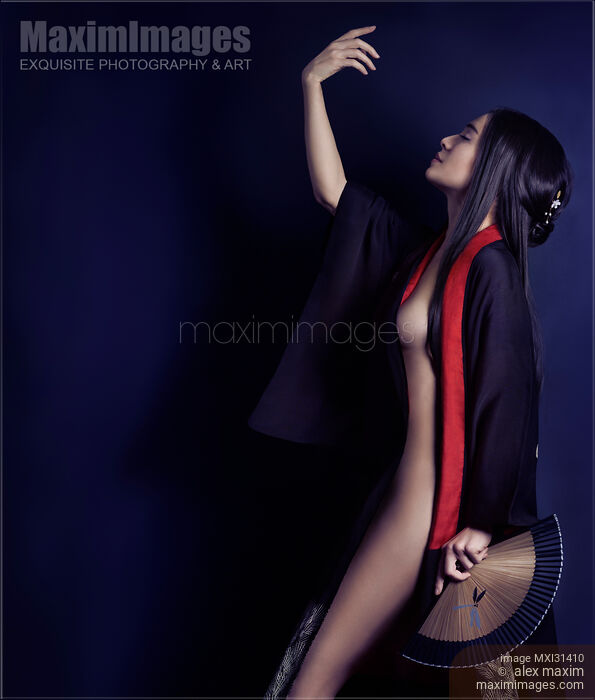 Artistic sensual portrait of a beautiful Asian woman with a hand fan wearing a black kimono partially revealing her nude body Stock photo of Artistic sensual portrait of a beautiful Asian woman with a hand fan wearing a black kimono partially revealing her nude body Buy commercial use license at MaximImages