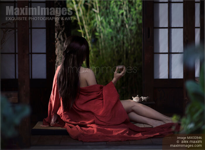 Asian woman in red kimono drinking tea half dressed by open shoji doors in a Japanese house Sensual portrait Stock photo of Asian woman in red kimono drinking tea half dressed by open shoji doors in a Japanese house Sensual portrait Buy commercial use license at MaximImages