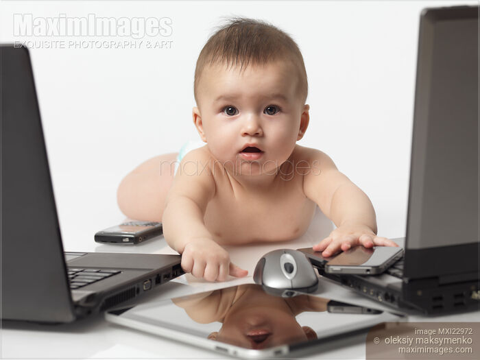 Stock photo of Baby amongst Computers and Electronics Buy commercial use license at MaximImages